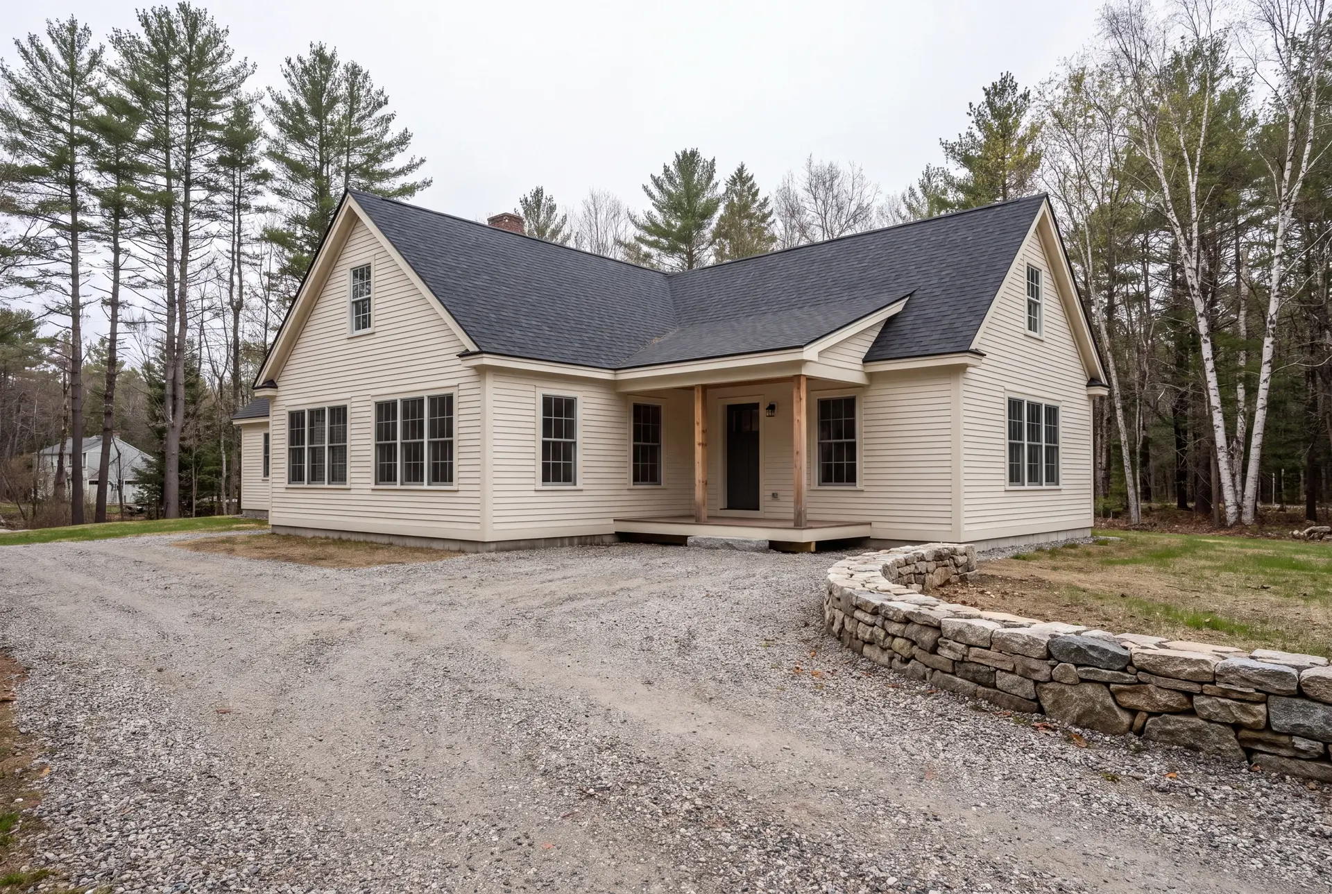 Illustration: A cream-colored farmhouse with a new addition, dark gray roof, and a covered porch, viewed from a gravel driveway with a stone wall