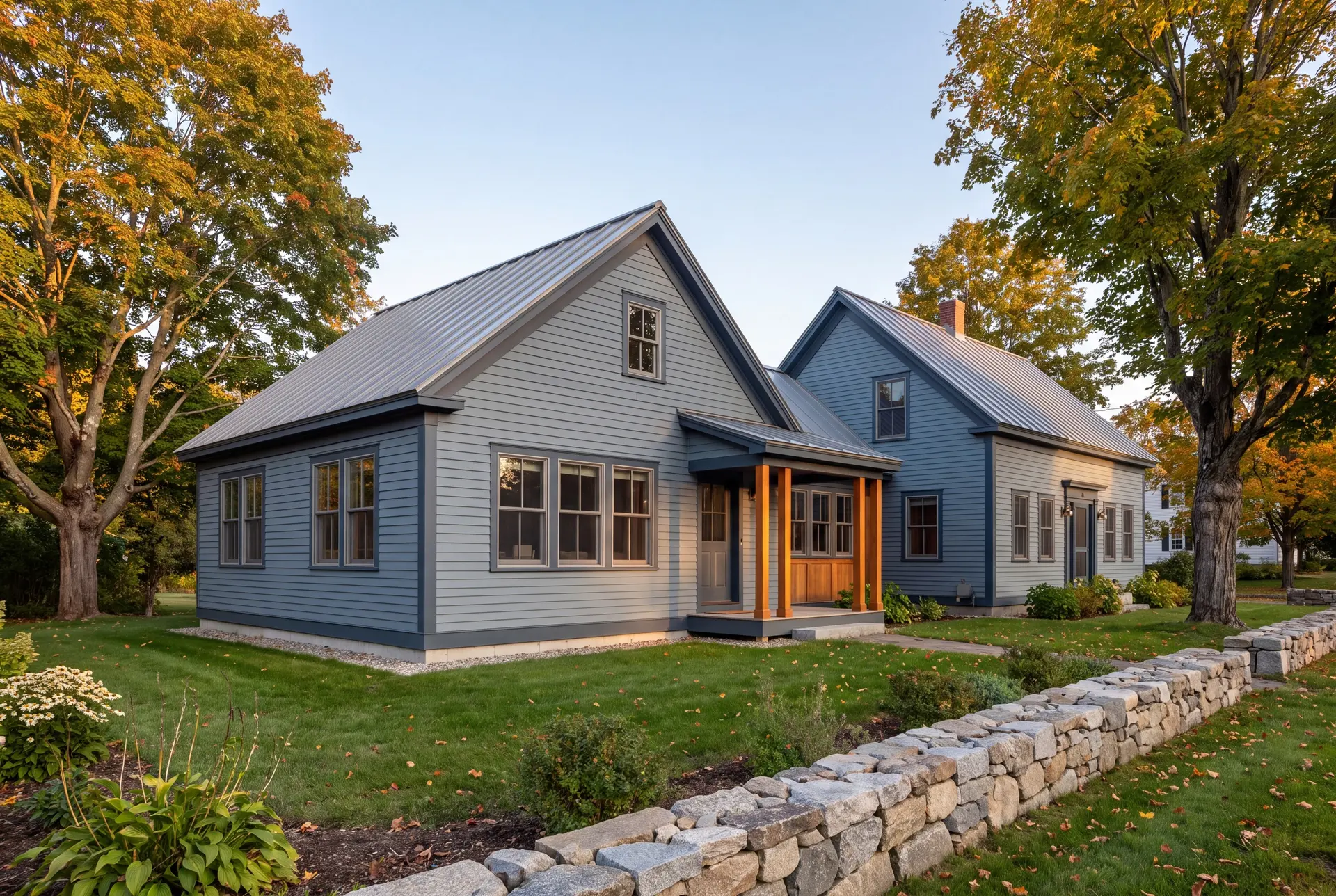 Illustration: A blue-gray farmhouse with a new addition, matching in style and materials, seen from a three-quarter exterior view with a stone wall in the foreground