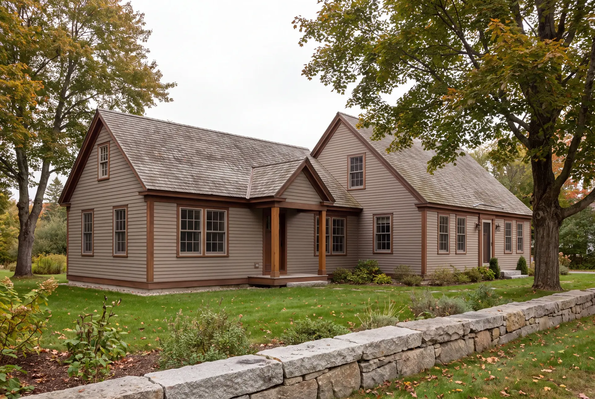 Illustration: A taupe clapboard house with a new addition, brown trim, and a gray shingle roof, seen from a three-quarter exterior view on a green lawn with a stone wall in the foreground