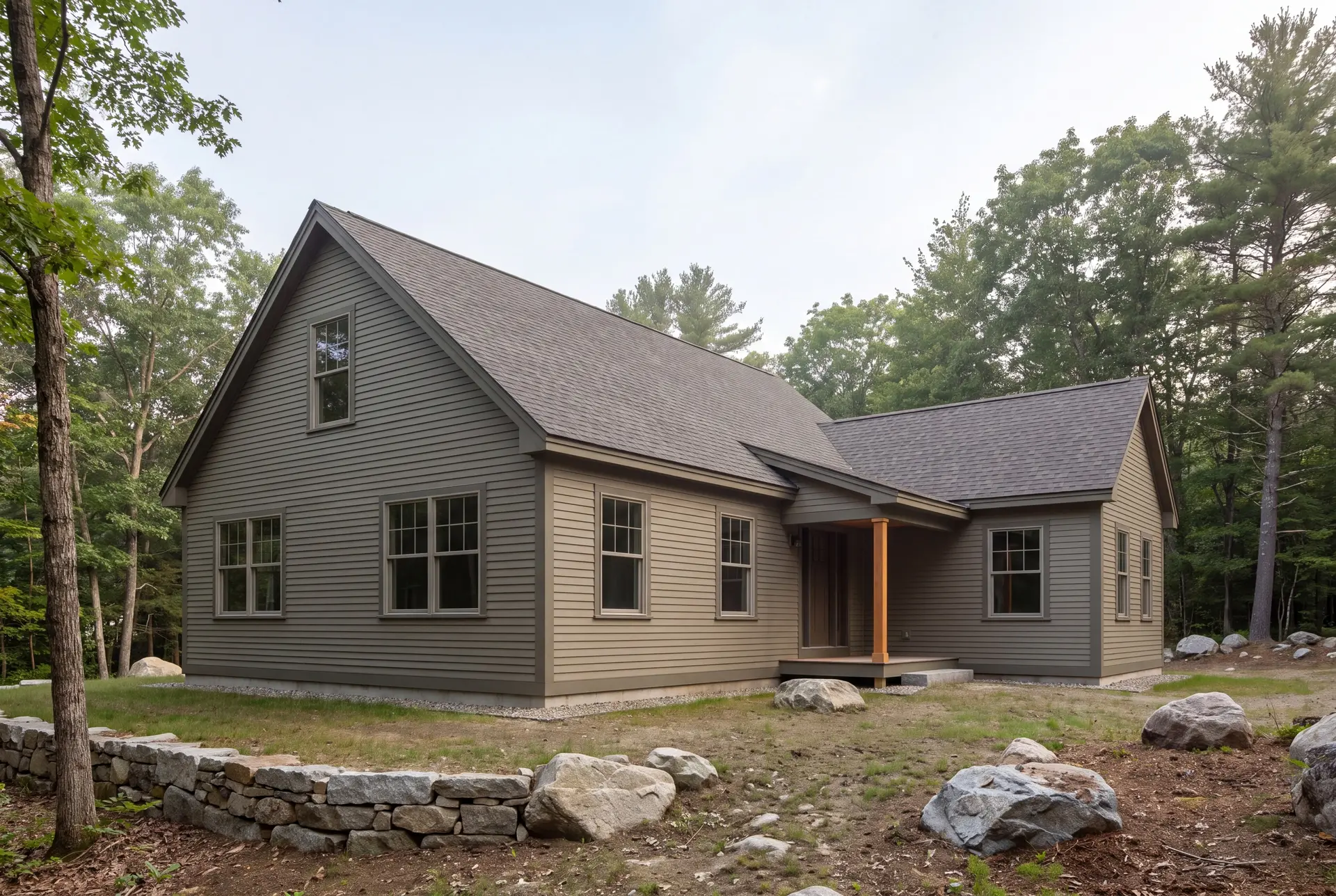 Illustration: A house with a gabled roof and an addition, featuring two different colors of clapboard siding, surrounded by trees and rocks