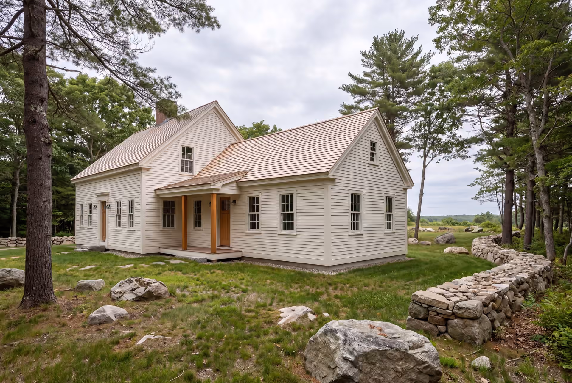 home addition builder in Saco, ME: illustrative scene, A traditional New England saltbox house with a new addition, both in warm white clapboard and cedar shake roofs, surrounded by a natural landscape of grass, rocks, and trees