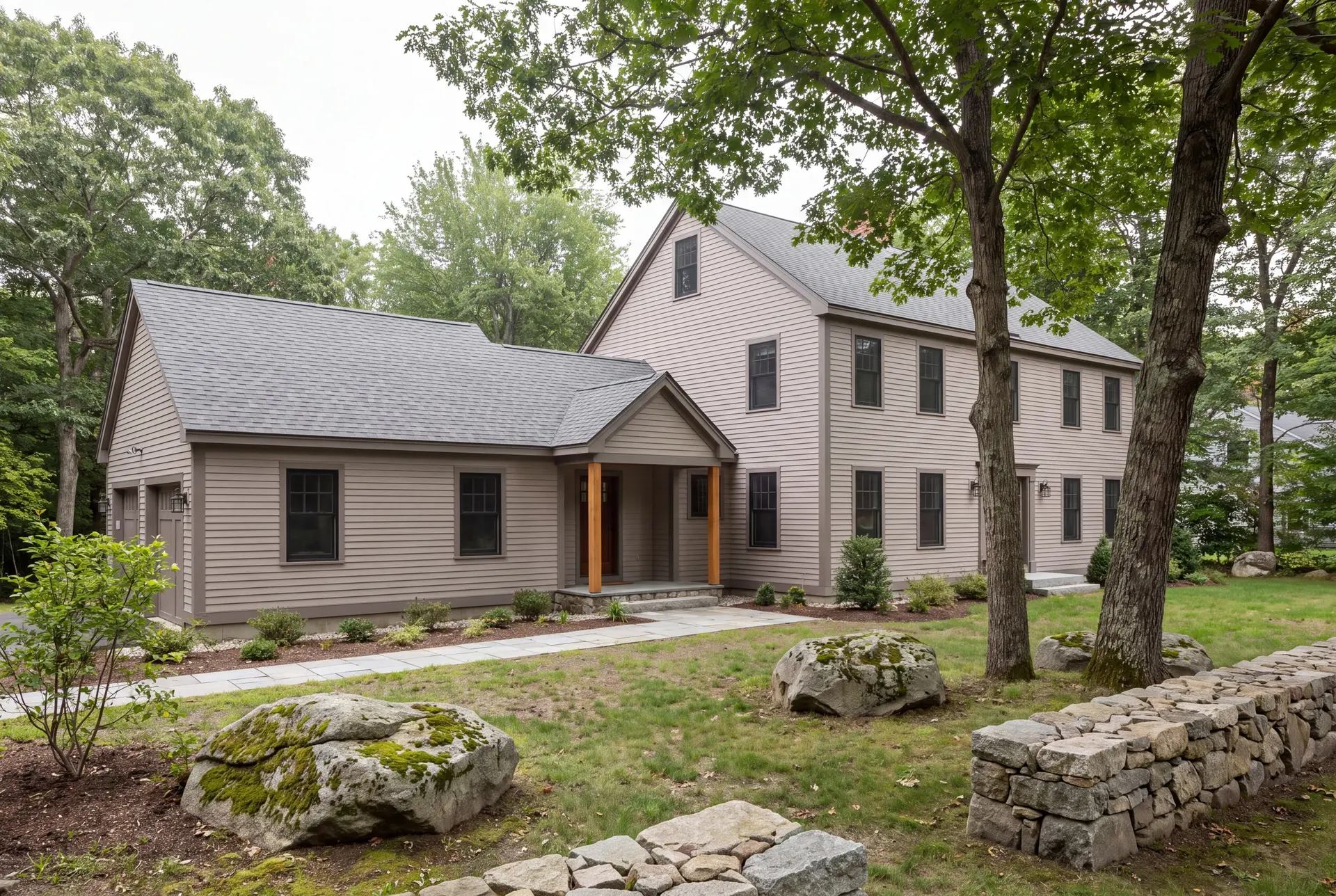 Illustration: A two-story Colonial house with a single-story addition, both in mushroom-colored clapboard siding, seen from a three-quarter exterior view with a stone path and trees in the foreground
