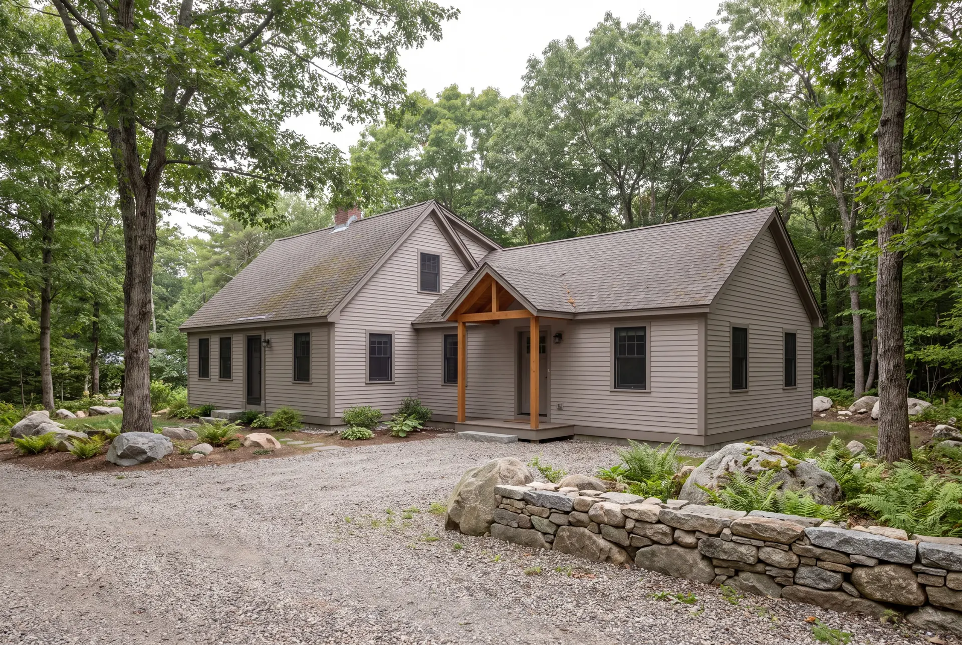 Illustration: A farmhouse with a new addition, featuring mushroom-colored siding and a covered entry, surrounded by trees and a gravel driveway